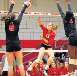  ?? GARY MIDDENDORF/DAILY SOUTHTOWN ?? Mother McAuley’s Connie LeBel (15) powers a shot through the block against Marist during a match on Thursday, Sept. 26, 2019.