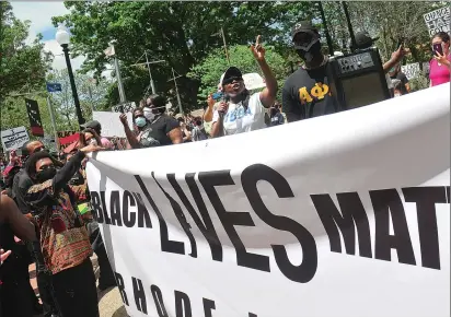  ?? Ernest A. Brown photos ?? Above, Lisa Ranglin, of Black Lives Matter Rhode Island, speaks during a George Floyd Rally in Burnside Park in Providence Saturday, shouting ‘Give it up for unity, we are stronger together!’ Below, thousands attended the rally in the city as part of protesting the death of George Floyd. It started at Burnside Park in Kennedy Plaza then moved to the steps of the Statehouse, where speakers spoke out against Floyd’s death. Protests have occurred in several major cities across the country.