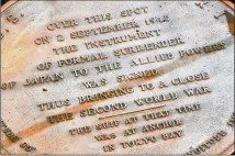  ?? CALEB JONES / AP ?? A plaque marks the spot where World War II surrender documents were signed on the USS Missouri and is being visited at the Pearl Harbor memorial in Hawaii to mark the 75th anniversar­y of Japan’s surrender and the end of World War II.