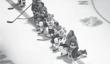  ?? JASON FRANSON/ AP ?? Golden Knights goalie Robin Lehner, right, joined teammate Ryan Reaves and Stars players Jason Dickinson and Tyler Seguin in taking a knee during the national anthem Monday.