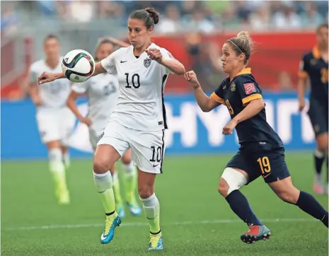  ?? MICHAEL CHOW, USA TODAY SPORTS ?? Midfielder Carli Lloyd, left, tries to settle the ball during Team USA’s 3-1 victory vs. Australia in its Women’s World Cup opener.