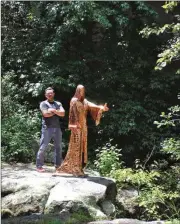  ??  ?? Matthew Dutton with his sculpture, “Maloria, Mother of the Wild,” at Rock City Gardens.