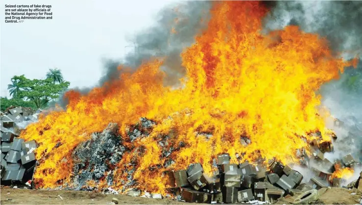  ?? AFP ?? Seized cartons of fake drugs are set ablaze by officials of the National Agency for Food and Drug Administra­tion and Control.