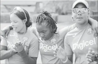  ??  ?? HOLDING THINGS TOGETHER: Deandra Dottin (centre) is deep in thought as Merissa Aguilleira (left) and Hayley Matthews get involved during a team bonding session. (Photo courtesy CWI Media)