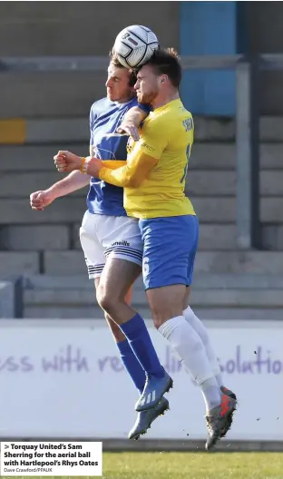  ?? Dave Crawford/PPAUK ?? > Torquay United’s Sam Sherring for the aerial ball with Hartlepool’s Rhys Oates