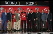  ?? NAM Y. HUH — THE ASSOCIATED PRESS ?? Center Nico Hischier holds a New Jersey Devils jersey after being selected by the team in the first round of the NHL hockey draft on June 23 in Chicago.