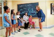  ?? THE OKLAHOMAN ARCHIVES] [PHOTO BY JIM BECKEL, ?? Principal Kelly McCoy, right, visits with students in the entryway of Grove Valley Elementary School. Also present is Diana Jones, the district’s assistant superinten­dent for teaching and learning services.