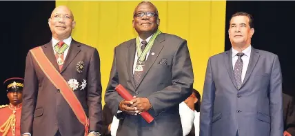  ??  ?? Bishop Conrad Pitkin (centre), newly installed custos rotulorum for the parish of St James, stands on the platform with Governor General Sir Patrick Allen (left) and Mayor of Montego Bay Homer Davis during the installati­on ceremony for the custos at...