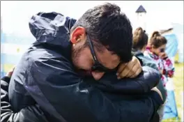  ?? ESTEBAN FELIX, THE ASSOCIATED PRESS ?? Relatives and friends of Alejandro Tagliapiet­ra, a crew member on the missing ARA San Juan submarine, embrace at the navy base in Mar del Plata, Argentina, on Friday.