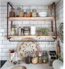  ??  ?? Rather than having wall units that would overwhelm the space, Maxine made the shelving out of scaffoldin­g boards and copper piping