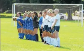  ?? DENNIS KRUMANOCKE­R (LEFT), AUSTIN HERTZOG - DIGITAL FIRST MEDIA ?? At left, Kutztown senior Niki Nolte, seated center, is joined by the Cougars’ girls soccer seniors before their cancer awareness game on Sept. 11. Above, the Kutztown and Oley Valley girls soccer teams line up for starting lineups. Below, Nolte hugs...