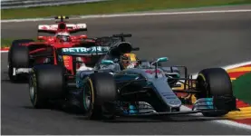  ??  ?? Lewis Hamilton in his Mercedes-Benz F1 W08 Hybrid and Sebastian Vettel in his Ferrari SF70-H battle at the Belgian Grand Prix.