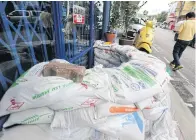  ??  ?? A store entrance is sealed with sandbags as residents prepare for a deluge in downtown Phetchabur­i later today.
