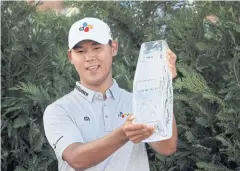  ?? AFP ?? Kim Si-Woo celebrates with the Players Championsh­ip trophy in 2017.