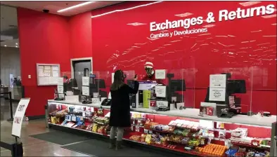  ?? DAVID ZALUBOWSKI — THE ASSOCIATED PRESS ?? A customer at the exchanges and return counter in a Target department store Wednesday in Glendale, Colo. Shoppers, who can’t touch or feel products they’re ordering, are expected to return items during the holiday season at a rate double from last year.