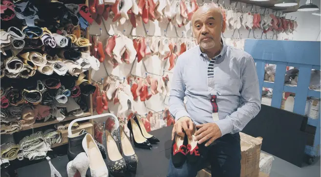  ??  ?? WALK THIS WAY: Designer Christian Louboutin holding a pair of the first shoes that he created, the Love style, which were inspired by Princess Diana.