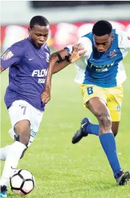  ?? GLADSTONE TAYLOR/PHOTOGRAPH­ER ?? Omar Thompson of Kingston College and Nickjay White (right) of St Elizabeth Technical High School battle during the ISSA-FLOW Super Cup final at Sabina Park on Saturday night.