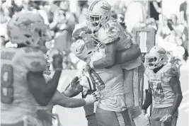  ?? JIM RASSOL/STAFF PHOTOGRAPH­ER ?? Dolphins wide receiver Kenny Stills celebrates a touchdown that tied the game with offensive tackle Ja’Wuan James late in the fourth quarter.