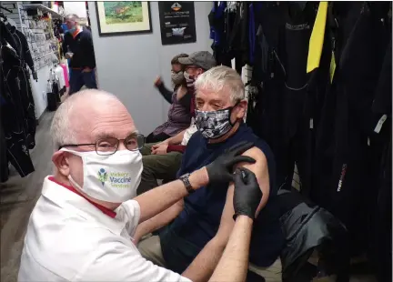  ?? BOB KEELER — MEDIANEWS GROUP ?? Pharmacist Jim Vickery prepares to give a COVID-19vaccine shot to Mark McElwee, of Eagleville, at Incian Valley Scuba’s Dive Club.