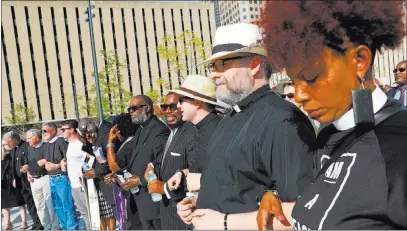  ?? Christian Gooden ?? St. Louis Post-dispatch Clergy pray together during an interfaith prayer service Tuesday at Kiener Plaza in St. Louis. Leaders of several faiths called for peace and justice amid the turmoil that followed the acquittal of a white former police officer...
