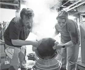  ?? NETWORK-WISCONSIN SARAH KLOEPPING/USA TODAY ?? Neil and Whitney Froelich pour boiling water into a container to start making a batch of Kolsch beer in their basement in Green Bay.