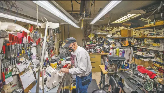  ?? (The Herald-Times/Rich Janzaruk) ?? “I know where everything is,” Glen Hilderbran­d said as he worked on a sewing machine at Klaiber’s Sewing Center in Bloomingto­n, Ind. Sewing machine fixers have never been so sought after as people bring them out from storage. They need to be lubricated and cleaned and the tension often needs adjusting.