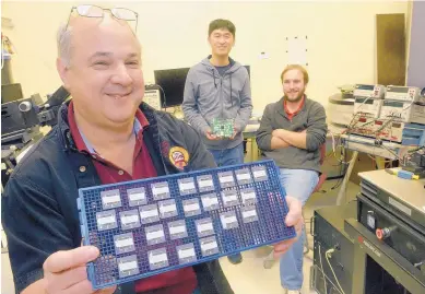  ?? GREG SORBER/ALBUQUERQU­E JOURNAL ?? Professor Jim Plusquelli­c, left, and Ph.D candidates Wenjie Che and Dylan Ismari test new hardware security that the University of New Mexico is commercial­izing through a new start-up, Enthentica Inc.