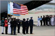  ?? AP PHOTO BY AHN YOUNG-JOON ?? A U.N. honor guard carries a casket containing remains believed to be from American servicemen killed during the 1950-53 Korean War after arriving from North Korea, at Osan Air Base in Pyeongtaek, South Korea, Friday, July 27.