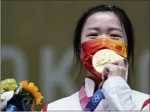  ?? ALEX BRANDON — THE ASSOCIATED PRESS ?? Yang Qian, of China, reacts after winning the gold medal in the women’s 10-meter air rifle at the Asaka Shooting Range in the 2020 Summer Olympics on Saturday in Tokyo, Japan.