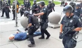  ?? MIKE DESMOND/WBFO NPR/AFP VIA GETTY IMAGES ?? A 75-year-old protester lies on the ground after being shoved by Buffalo, N.Y., police on Thursday.