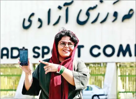  ?? ATTA KENARE/AFP ?? Iranian sports journalist Raha Pourbakhsh shows purchased electronic tickets for the Iran v Cambodia World Cup 2022 qualifier in front of Azadi stadium in the capital Tehran on Tuesday. After a ban spanning decades, Iranian women are set to freely enter a football stadium for the first time on Thursday.