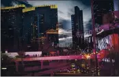  ?? WONG MAYE-E — THE ASSOCIATED PRESS ?? Casinos and other businesses are seen reflected in the glass walls of an overpass along the Las Vegas Strip.