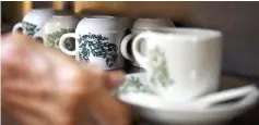  ??  ?? Tan’s Kopitiam Kampung Parit still uses the original design for his coffee cups.