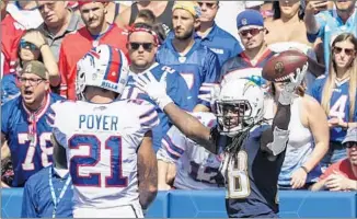  ?? Robert Gauthier Los Angeles Times ?? RUNNING BACK Melvin Gordon of the Chargers celebrates next to safety Jordan Poyer of the Buffalo Bills after scoring a touchdown in the second quarter on a pass from Philip Rivers.