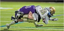  ?? BOB TYMCZYSZYN TORSTAR ?? A.N. Myer’s Winfield Organ, left, tackles Sir Winston Churchill’s Benjamin Aylward in Division 1 senior high school championsh­ip football Friday night in Niagara Falls.