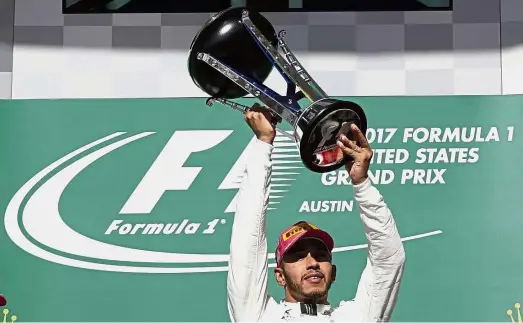  ?? — AP ?? Dominating form: Mercedes’ Lewis Hamilton lifting the trophy after winning the United States Grand Prix at the Circuit of the Americas in Texas on Sunday.