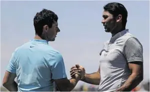  ??  ?? Over and out: Rory McIlroy, left, and Jason Day shake hands on the last after bowing out of the event on five-over 149 and 10-over 154 respective­ly