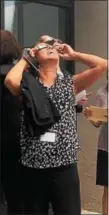  ?? CARL HESSLER JR. — DIGITAL FIRST MEDIA ?? People inside the Montgomery County Court House made their way outside to check out the partial eclipse over Pennsylvan­ia on Monday afternoon.