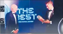  ?? PHOTO/ AP ?? Robert Lewandowsk­i (right) was crowned World player of the year and presentedw­ith the trophy by Fifa president Gianni Infantino.