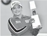  ??  ?? Jang Ha-na of South Korea poses with the trophy after winning the BMW Ladies Championsh­ip in Busan, South Korea, yesterday. — AFP