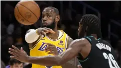  ?? AP/MARK J▪ TERRILL PHOTO ?? LOS ANGELES Lakers forward Lebron James, left, passes the ball as Portland Trail Blazers forward Justise Winslow defends during the first half of an NBA basketball game Wednesday, Nov▪ 30, 2022, in Los Angeles▪