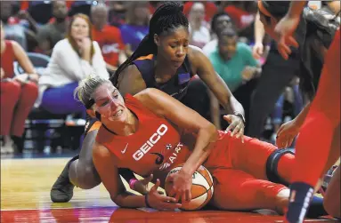  ?? Will Newton / Getty Images ?? The Mystics’ Elena Delle Donne, front, battles the Sun’s Jonquel Jones for the ball during Game 1 of the WNBA Finals on Sunday.