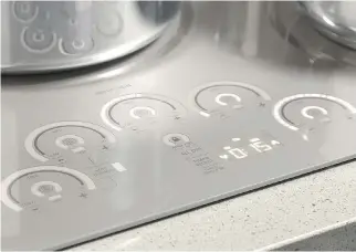  ??  ?? Below: Monogram’s 36-inch induction cooktop, with a Glide Touch interface that’s as “smooth and silky as using your iPhone.” It’s designed with those who have limited mobility in mind.