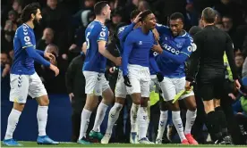  ?? Photograph: Paul Ellis/AFP/Getty Images ?? Everton’s Demarai Gray (second from left) is congratula­ted for his stoppage-time winner against Arsenal.