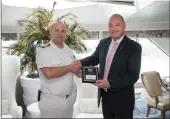  ??  ?? DA parliament­ary spokespers­on on tourism, James Vos, and the captain of the Crystal Symphony, Nenad Wilheim, with a plaque to commemorat­e the first world cruise to depart from Cape Town’s new cruise terminal.