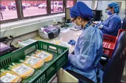  ?? GUILLERMO LEGARIA/GETTY IMAGES ?? Researcher­s work with samples of plasma donated by patients who recovered from COVID-19 on Aug. 14 in Bogota, Colombia.