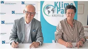  ?? FOTO: KR ?? Dezernenti­n Sabine Lauxen und Dr. Thomas Grünewald, Präsident der Hochschule Niederrhei­n, haben die Klimaschut­zvereinbar­ung unterzeich­net.