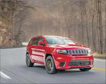  ?? Photograph­s by Fiat Chrysler Automobile­s ?? THE 707-HORSEPOWER 2018 Jeep Grand Cherokee Trackhawk sits high like an SUV but rides more quietly than most SUVs, with little wind noise and road noise despite the massive 20-inch wheels.