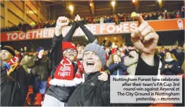  ??  ?? Nottingham Forest fans celebrate after their team’s FA Cup 3rd round win against Arsenal at The City Ground in Nottingham yesterday. –