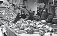  ?? Li-Cycle/Tribune News Service ?? Li-Cycle employees feed lithium-ion batteries into a shredder at a Canada facility.